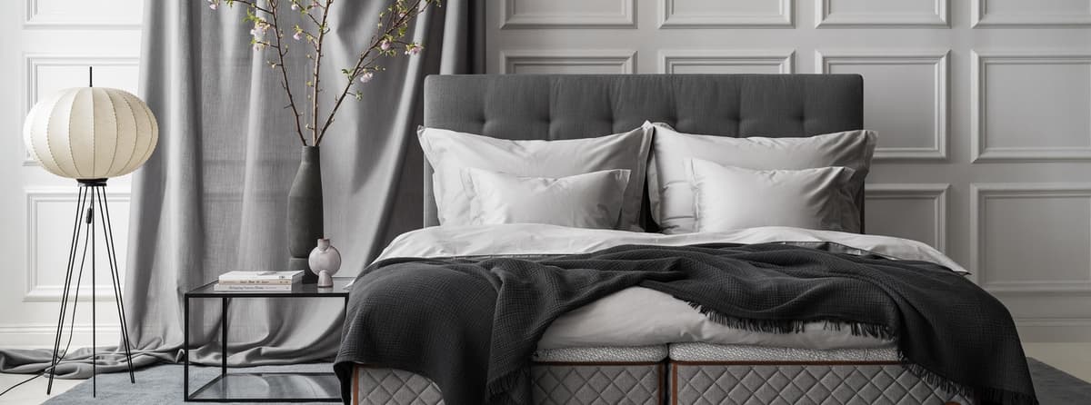 Bedroom environment with the DUX bed model 2002 and Dante headboard