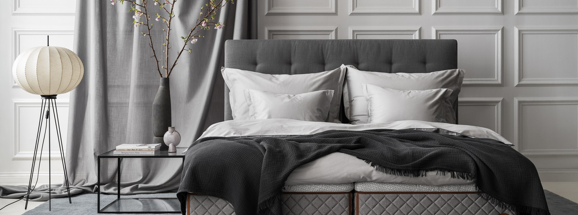 Bedroom environment with the DUX bed model 2002 and Dante headboard